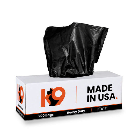 White K9 carton of 200 heavy duty 8 by 13 inch roll bags with a black bag pulled from the top